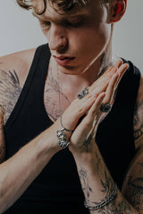 Side angle view of the Sterling Silver Oni Mask Pendant, highlighting the sharp horns and 3D details.