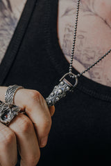 Side angle view of the Sterling Silver Skull Bullet Pendant, highlighting the red gemstone accents and 3D design.