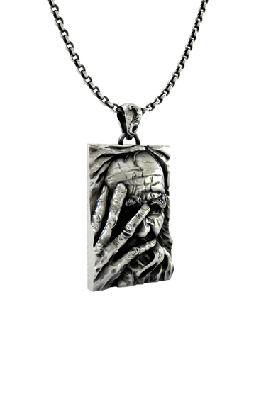 Side angle view of the Sterling Silver Wise Wizard Pendant, highlighting the deep, 3D relief of the sculpture.