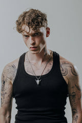 Taurus Bull Pendant shown on a model to demonstrate its substantial size and powerful aesthetic.