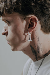 Uzi Rifle Earring shown with a size reference to demonstrate its actual dimensions and drop length when worn