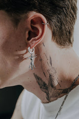 Vitruvian Man Earring shown with a size reference to demonstrate its actual dimensions and drop length when worn