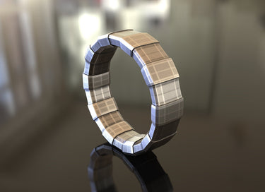 3D render of a geometric silver ring showing the segmented construction and brushed metallic texture on a reflective surface.