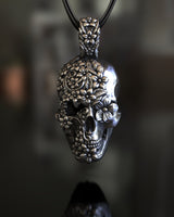 925 sterling silver sugar skull pendant with detailed floral engravings displayed on dark background