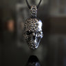 925 sterling silver sugar skull pendant with detailed floral engravings displayed on dark background