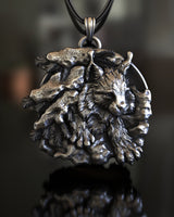 Detailed close-up of the silver lynx pendant showing the intricate fur texture, pine branches, and oxidized finish.