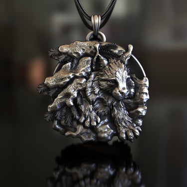 Detailed close-up of the silver lynx pendant showing the intricate fur texture, pine branches, and oxidized finish.
