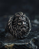 925 sterling silver Poseidon ring with detailed Greek god face and trident crown on dark stone surface