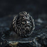 925 sterling silver Poseidon ring with detailed Greek god face and trident crown on dark stone surface