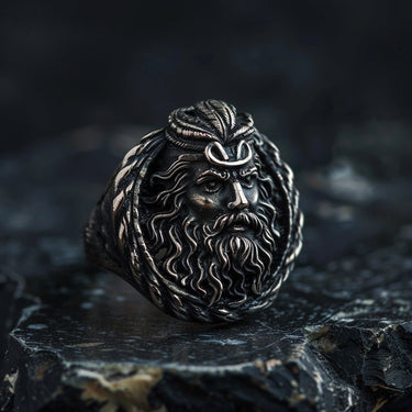 925 sterling silver Poseidon ring with detailed Greek god face and trident crown on dark stone surface