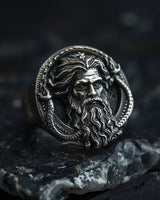 925 sterling silver Poseidon ring with detailed Greek god face and serpent design on dark stone background