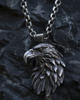 925 sterling silver eagle pendant with detailed feather carving displayed on dark stone background