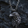 925 sterling silver eagle pendant with detailed feather carving displayed on dark stone background