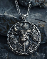 925 sterling silver bull pendant with cloud motifs displayed on dark stone background showing intricate details