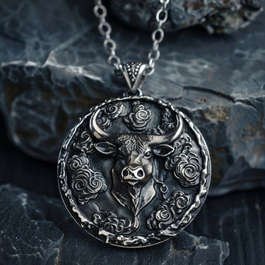 925 sterling silver bull pendant with cloud motifs displayed on dark stone background showing intricate details
