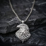 925 sterling silver eagle head pendant with detailed feathers displayed on dark stone background showing craftsmanship