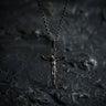 925 sterling silver crucifix pendant with Jesus Christ figure displayed on dark textured stone background