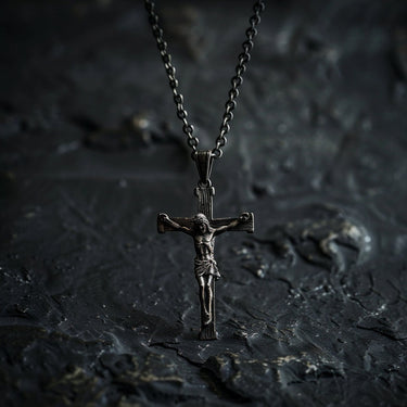 925 sterling silver crucifix pendant with Jesus Christ figure displayed on dark textured stone background