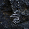 925 sterling silver eagle head pendant with detailed feathers and oxidized finish on dark stone background