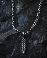 925 sterling silver wheat ear pendant with detailed leaf pattern displayed on dark stone background