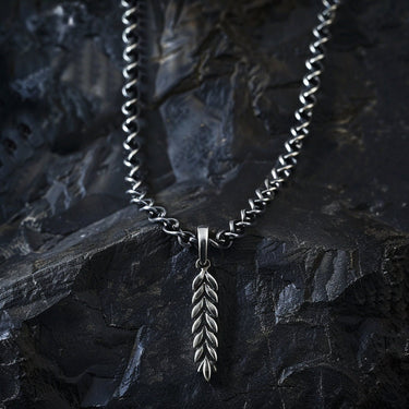 925 sterling silver wheat ear pendant with detailed leaf pattern displayed on dark stone background