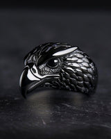 925 sterling silver eagle ring with detailed feathers and curved beak displayed on dark textured background