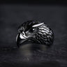 925 sterling silver eagle ring with detailed feathers and curved beak displayed on dark textured background