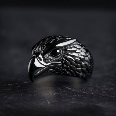 925 sterling silver eagle ring with detailed feathers and curved beak displayed on dark textured background