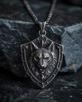 925 sterling silver wolf shield pendant with detailed wolf head design displayed on dark stone background