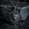 925 sterling silver wolf shield pendant with detailed wolf head design displayed on dark stone background