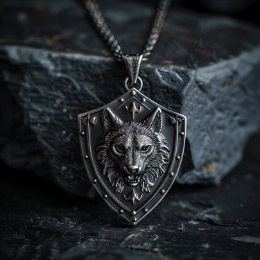 925 sterling silver wolf shield pendant with detailed wolf head design displayed on dark stone background