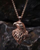925 sterling silver eagle head pendant with rose gold plating showing detailed feather work against dark background