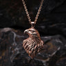 925 sterling silver eagle head pendant with rose gold plating showing detailed feather work against dark background