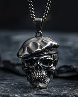 925 sterling silver skull beret pendant necklace displayed on dark textured surface with chain