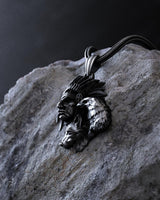 Side view of the handcrafted Native American pendant showing the 3D relief of the tribal chief and spirit animals.