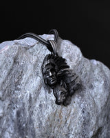 Detailed Native American pendant with a snake chain, showcasing the intricate feathers of the headdress against a dark background.