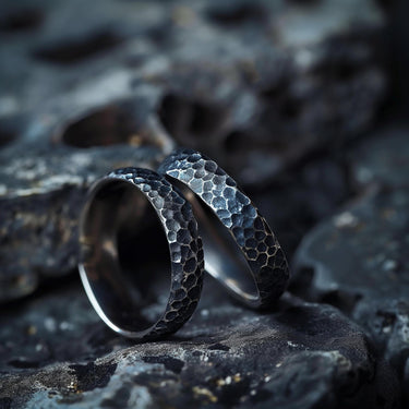 925 sterling silver hammered textured rings with honeycomb pattern displayed on dark stone surface background