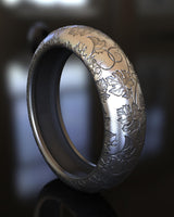 Side angle of premium 925 silver nature ring displaying leaf motifs and comfortable band width on modern surface