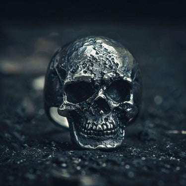 925 sterling silver skull ring with weathered bone texture and oxidized finish on dark background showing fine detail