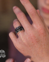 Gothic demon skull ring worn on a finger, displaying its size and bold statement style in natural lighting for context.