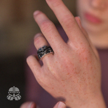 Gothic demon skull ring worn on a finger, displaying its size and bold statement style in natural lighting for context.