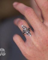 A woman wearing the nature-inspired Silver Leaf Ring, showing how the elegant bypass design wraps gracefully around the finger.