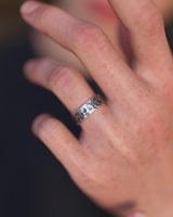 A unisex hammered silver Moon ring with a celestial lunar texture worn on a person's finger, showing its fit and style.
