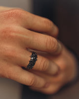 A man wearing the gothic-style Hannya mask ring, showcasing its fit and the bold, antique finish on his finger.