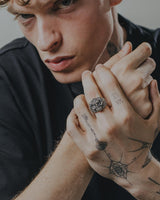 Japanese demon ring worn on the ring finger of a man with tattoos, showcasing its bold size and edgy style for men's fashion.
