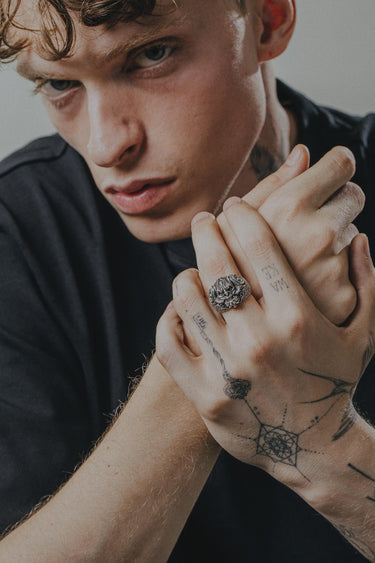 Japanese demon ring worn on the ring finger of a man with tattoos, showcasing its bold size and edgy style for men's fashion.