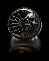 Detailed 3D render of the silver skull ring showing the crescent moon, skull, and sun design on an oxidized background.
