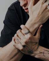 Man wearing handcrafted Celtic knot ring showing detailed Norse-inspired knotwork and oxidized silver finish