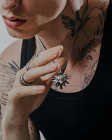 Side view of sterling silver wolf medallion pendant displaying three-dimensional spikes and wolf head detail