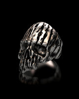 Three-quarter profile view of the men's Textured Silver Skull Ring, highlighting the skull's organic, carved pattern and deep eye sockets.